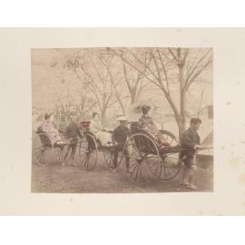 Three women being transported in a rickshaws