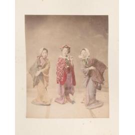Three girls posed in traditional dress