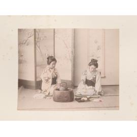 Two women pouring tea