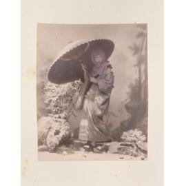 Woman standing with a parasol in the snow 
