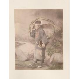 Boy carrying tools and grass