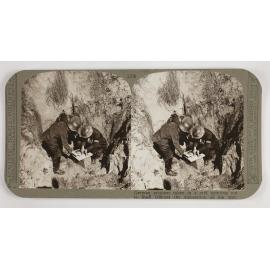 German prisoner taken in a raid pointing out to Staff Officers the disposition of his unit