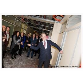 Professor John Redmond, Dean of Art and Design, smashes a door down as a symbolic start of the renovation of new facilities for MUMA at the Caulfield Campus