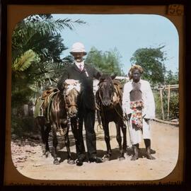 Travellers posing with horses and Indonesian people