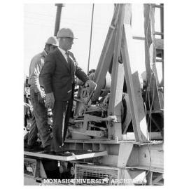 Site of Project A and B, Caulfield Institute of Technology. Director Mr Hartley Halstead lends a hand during preparation of the site