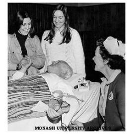 Caulfield Institute of Technology Director, Mr Hartley Halstead with students receiving moral support from students while giving blood to the Red Cross Bloodbank