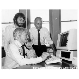 Computer training, Professor John Legge (seated), Mike Manning (left) of Arts faculty's computer training program, and Peter Slaney from IBM