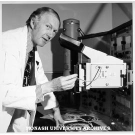 Associate Professor Eric Glasgow using scanning electron microscope