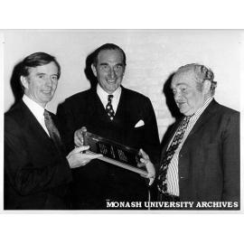 Presentation of plaque to Professor Joe Bornstein. CSL Director Dr N. McCarthy (left) and Chairman Mr Ross Shelmerdene (centre)
