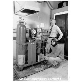 Dr Alan Holder (standing) and research assistant Russell Mills with reactor vessel