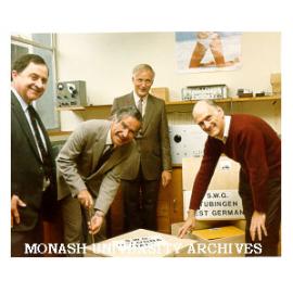 Vice-Chancellor Professor Ray Martin sealing first export model of square wave generator, with Mr Peter Wade (left), Professor Ron Brown and Mr Ron Beach