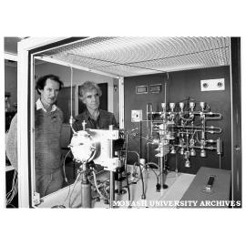 Associate Professor Ron Dickson (right) and Dr Ian Christiansz of Telecom Research Laboratories looking at metal organic chemical vapour deposition equipment