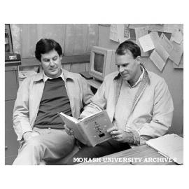 Dr Michael Taylor (right) and Dr Peter Newton (CSIRO) with their book 'Microcomputers for local government planning and management'