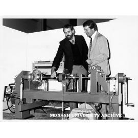 Professor Noel Murray (left) and Mr Bill Atkinson with machine to test spline shaft