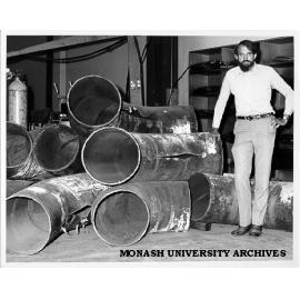 Professor Noel Murray showing rips in mitre bends of tested pipes