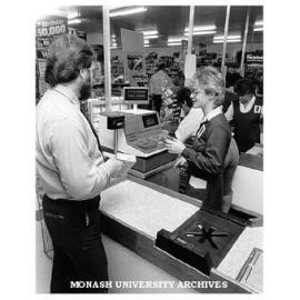 Dr Robin Shaw with cashier Sandra Botham at Schulz Licensed Supermarket, Syndal