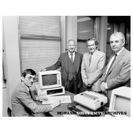 Mr Gordon McAuslan of IBM (second from left) with PC donated to Faculty of Economics and Politics. With him from left: Dr Rob Willis, Professor Ray Martin, and the Dean Professor Gus Sinclair