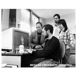Student Damian Conway in graphics laboratory, watched by Mrs Marian Cottingham (left), Mr Anthony Maeder and Dr Binh Pham