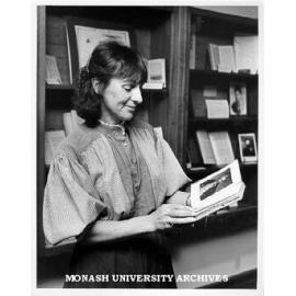 Marion Amies with items from exhibition in Main Library