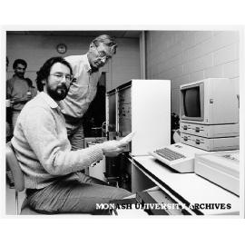 Dr Bob Gregory at isotope ratio mass spectrometer delivered by Mr Herbert Grebe (standing) of Finigan Mat Corporation
