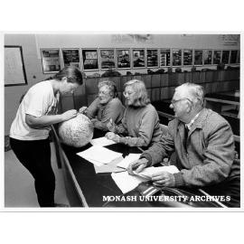 Natalie Schroeder explaining plate tectonics to CAE students, from left: Zena Hafner, Mary Walters and Jack Lawrence