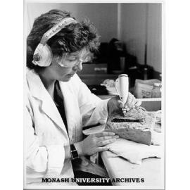 Research assistant Lesley Kool, separating dinosaur bone from rock
