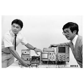 Winner of IEEE award Albert Fu (left), and Dr Khee Pang demonstrating digital filter