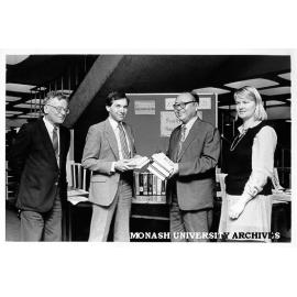 Professor Michael Pryles accepting gift of books from Professor Wa Da-Ying of Peoples' Republic of China, 12th International Congress of Company Law; Acting Dean of Law, Associate Professor Henry Finlay looking on