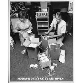 Professor Merle Ricklefs opening consignment of microfilm from Dutch National Archive