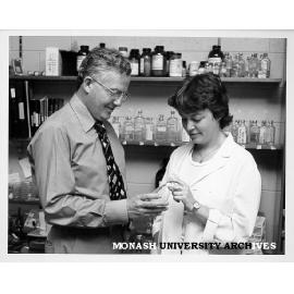 Professor Bruce Holloway and research assistant Mandy Moore examining bacterium