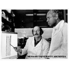 Associate Professor Viji Krishnapillai (right) discussing DNA sequence with Professor Bob Hancock from University of British Columbia