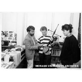 Mr Basoeki Koesasi showing Paul Shea how to play rebab, Paula Michelotti looking on