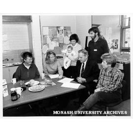 Federal Attorney-General Mr Lionel Bowen (seated second right) at Springvale Legal Service, with from left: Chris Slattery, Susanne Liden, Sue Miller and baby, Simon Smith service coordinator, and Judy Taylor