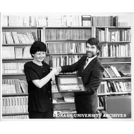 Helen Marriott being presented with word processor with Japanese keyboard, by Fujitsu Australia's Gary Ceasar