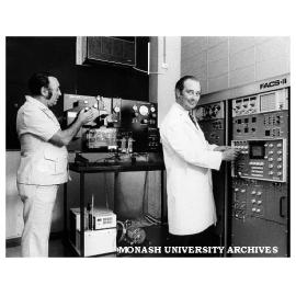Lab manager Mr Colin Cusdin (left) and chairman of Pathology and Immunology Professor Richard Nairn making adjustments to Fluorescence Activated Cell Sorter