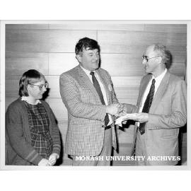 Mr Graeme Aspinall (centre) from Apex, presenting Professor Graeme Schofield, with contribution towards research at Centre for Early Human Development Miss Rosemary Horne looking on.