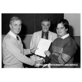Dr A. Gittins presenting BHP Prize to Bruce Crawford. Professor R. W. Cahn of Cambridge University looking on
