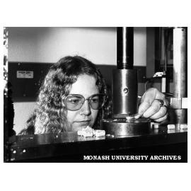 Animal technician Ms Alecia Jones feeding food pellet into compression rig