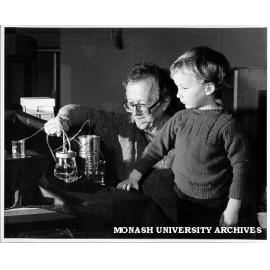 Dr Carl Moppert showing son Doran how M-pump works