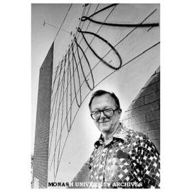 Senior lecturer Dr Carl Moppert with sun dial on wall of Union building