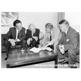 Signing of affiliation agreement between Monash and Bureau of Meteorology, from left: Professor John Swan, Professor Kevin Westfold, Dr John Zillman, Bureau director, and Mr Jim Butchart, University Registrar
