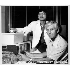 Associate Professor G. Bentley (right) and student John Wong using activity meter to test drug effects