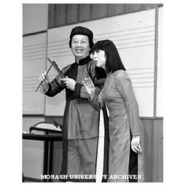 Vietnamese music scholar Tran Quang Hai playing coin clappers while wife Bach Yen sings