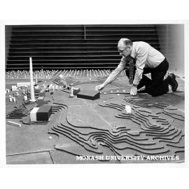 Technical officer George Perry with model of Mt Isa chimney stack used to calculate wind speed and test its effects