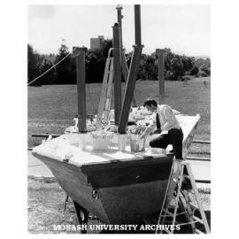 Dr Jon Hinwood inspecting Scylla, undergoing refurbishment prior to launch in Hobson's Bay