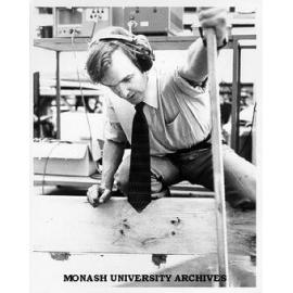 Associate Professor Jon Hinwood measuring wave generated by wave tank