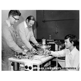 Technical officer Mervyn Roberts (left), Dr Alex McLaren and Dr Ig Tsong, with ion beam spectochemical analyser (IBSCA)