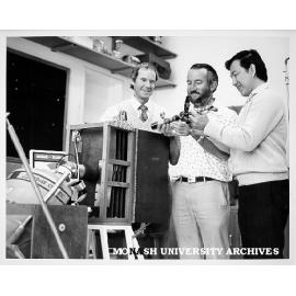 Dr John Cashion (left), Dr Trevor Finlayson and Dr Soi Sang Ti examining cryostat
