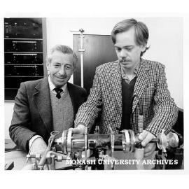 Dr Rod Tobin (left) and student Nigel Perry checking experimental metal vapour laser