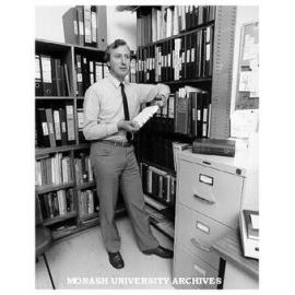 Dr John Pilbrow with records relating to his compact electron spin resonance spectrometer
